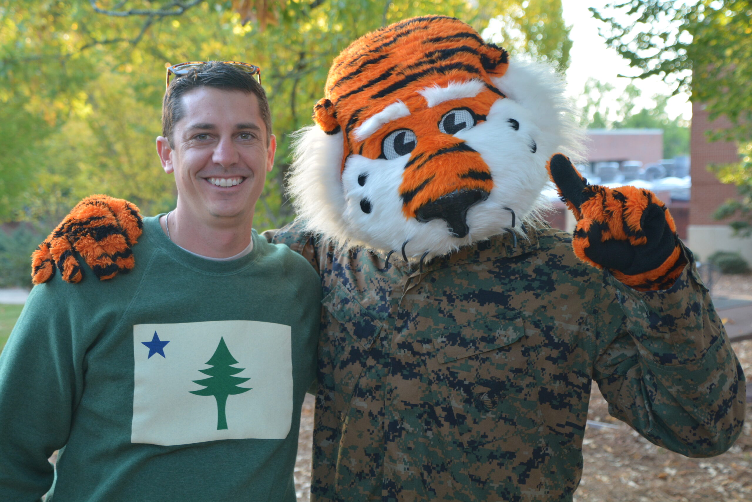 Tiger mascot wearing a military uniform posing with an ASVA member.